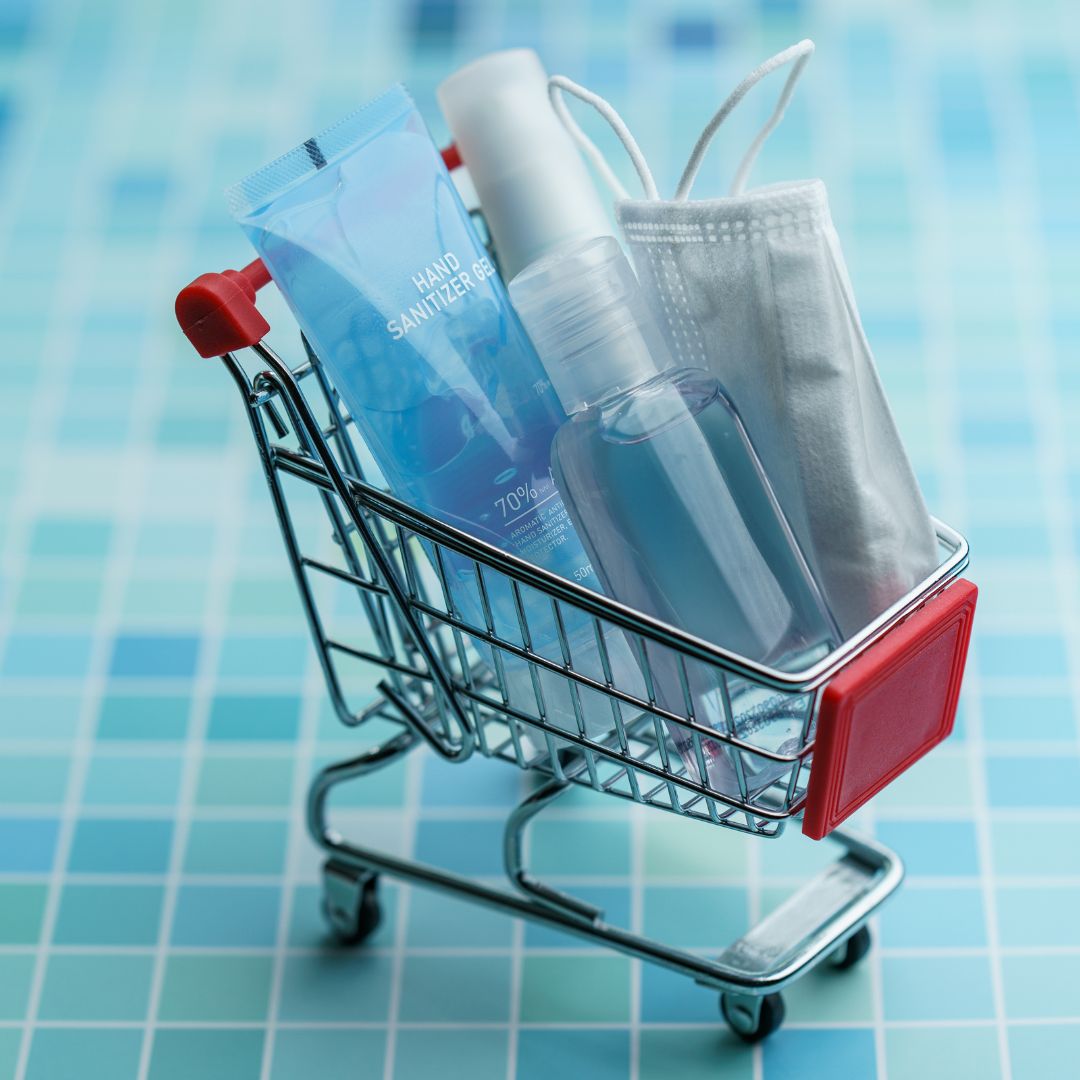 tiny shopping cart on a hospital floor with essential to go items for when you visit the hospital for pregnancy 
