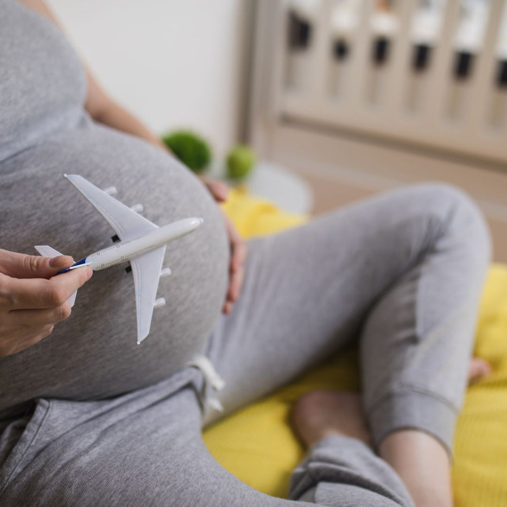 pregnant woman holding an airplane 